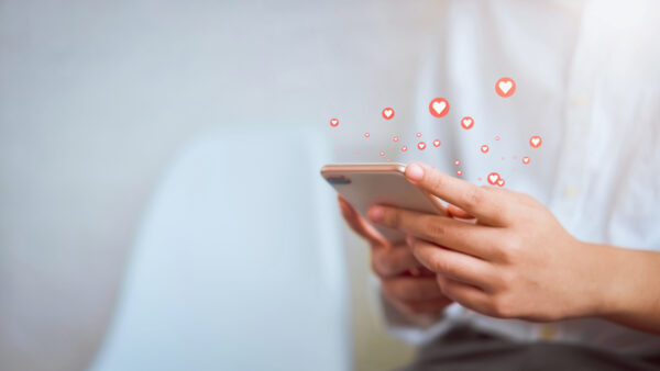 Marketer sharing brand email campaign on social media.