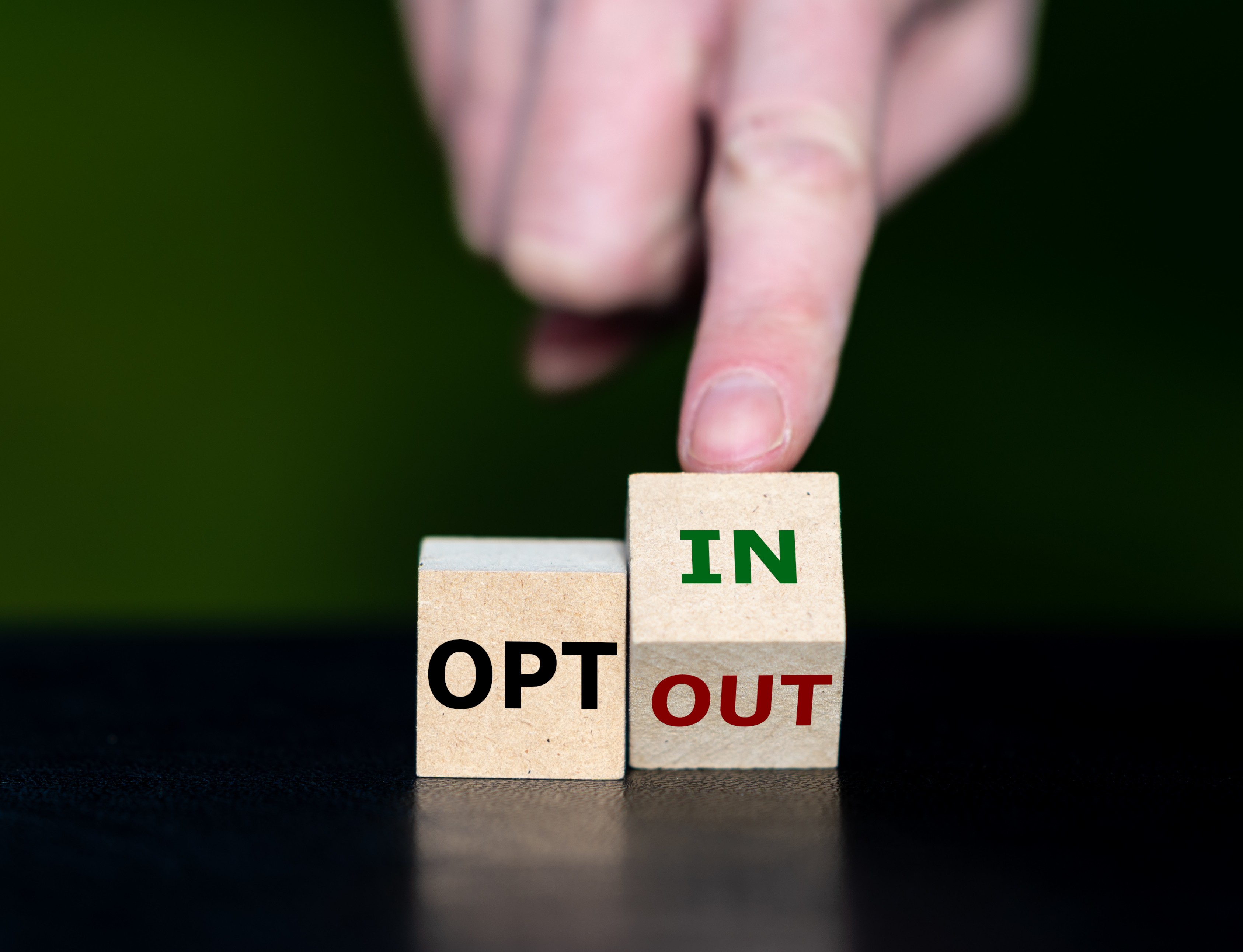 Two cubes with the words “opt in” and “opt out”