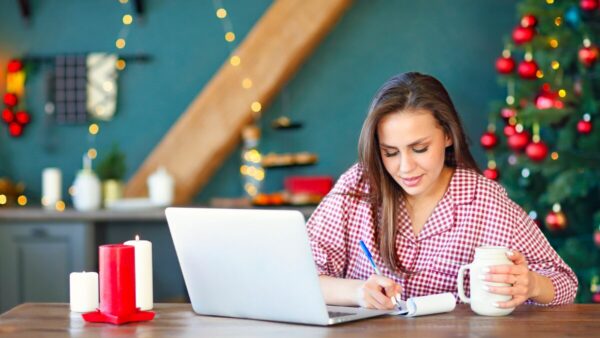Woman working with christmas decorations in the background, happy and stress-free