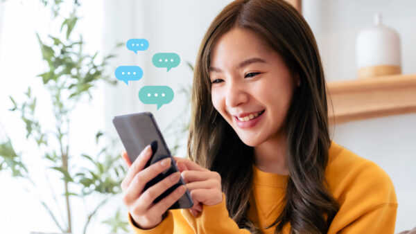 Marketer engaging in a two-way WhatsApp conversation with a customer on their smartphone.